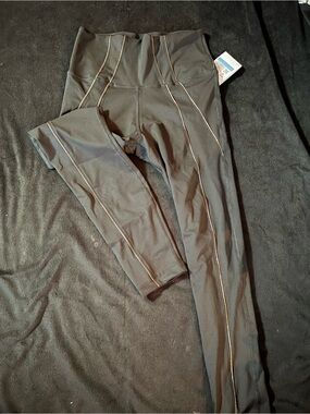 Nike Yoga Dri Fit Black Leggings with Gold Contrast Piping
